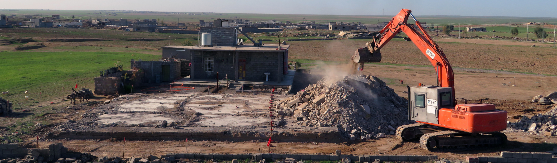 Armoured construction machine used to clear rubbles from destroyed building