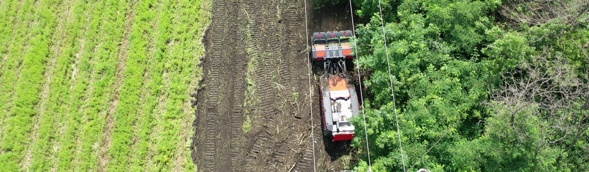 Ground preparation machine used to support demining operations near power lines